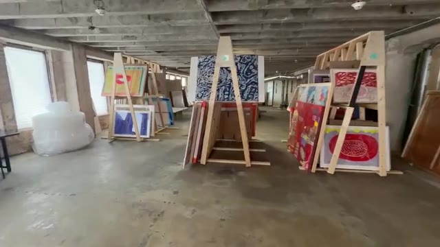 Artworks on wooden racks inside the Floyd Newsum Jr. art archive