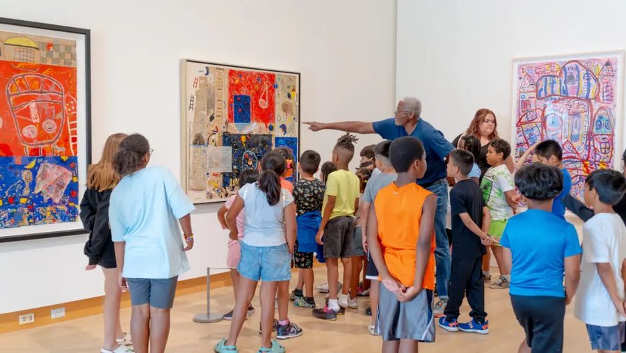 Floyd Newsum Jr. leading a museum tour for a group of children